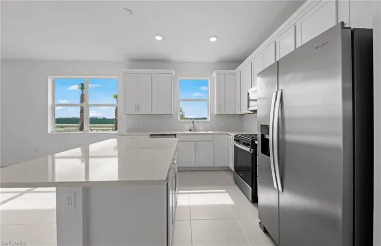Spacious kitchen w/ island - quartz countertops and stylish backsplash