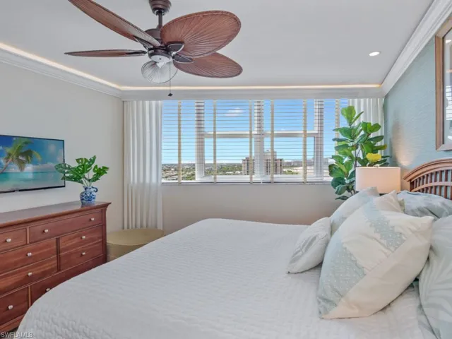 Bedroom featuring crown molding and a ceiling fan