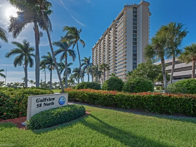 Community / neighborhood sign featuring a yard