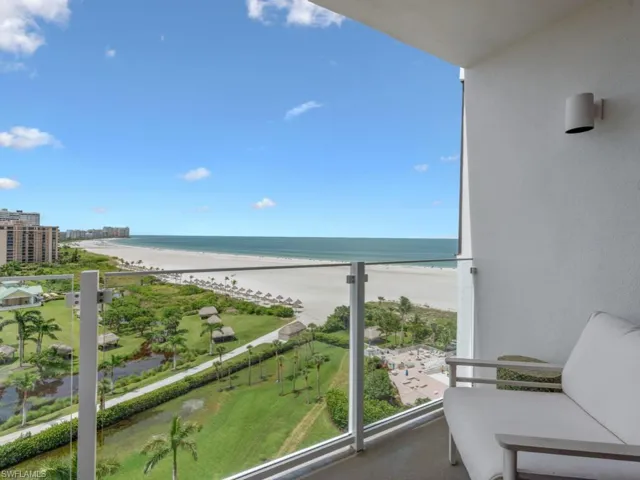 Balcony with view of water and beach