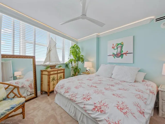 Carpeted bedroom with crown molding and a ceiling fan