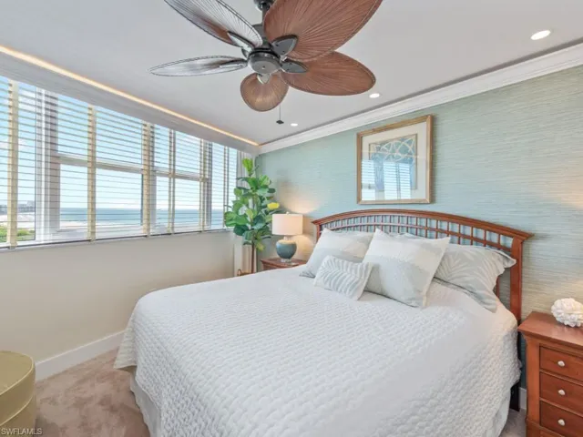Carpeted bedroom featuring recessed lighting, crown molding, and ceiling fan