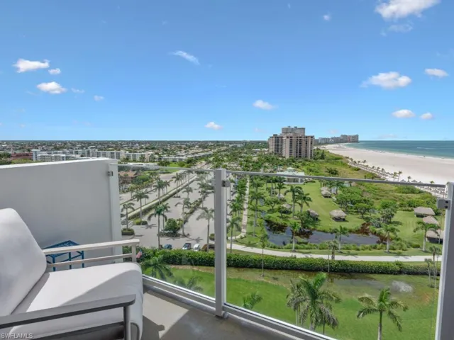 Balcony with view of water and beach