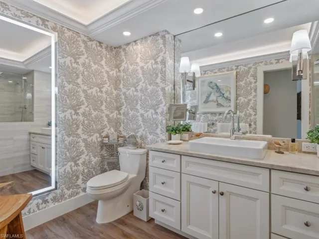 Bathroom featuring wallpapered walls, vanity, wood finished floors, recessed lighting, and a shower