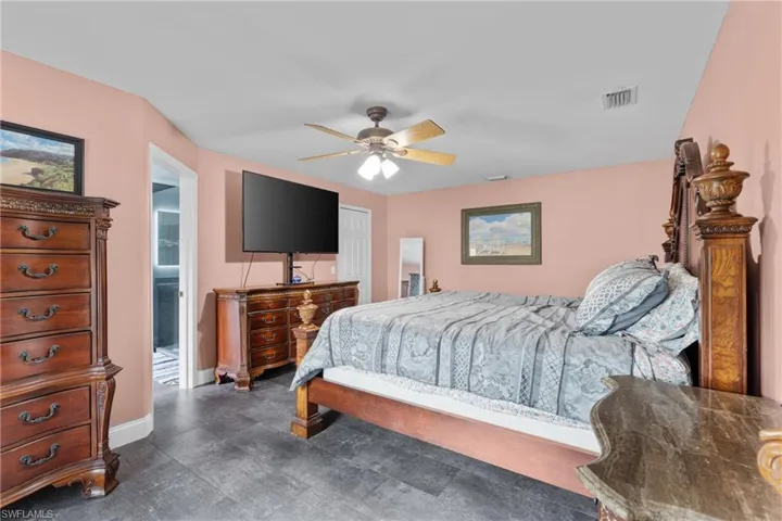 Bedroom with a ceiling fan and baseboards