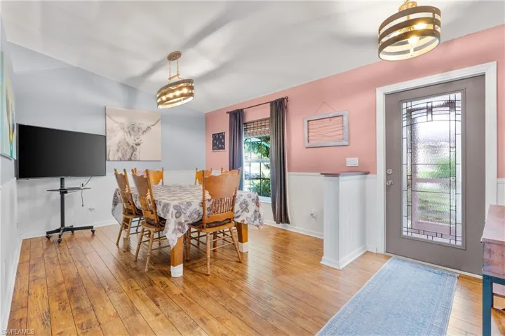 Dining room with a chandelier and wood-type flooring