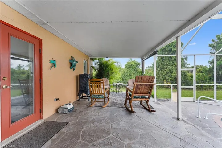 View of patio featuring a sunroom and a lanai
