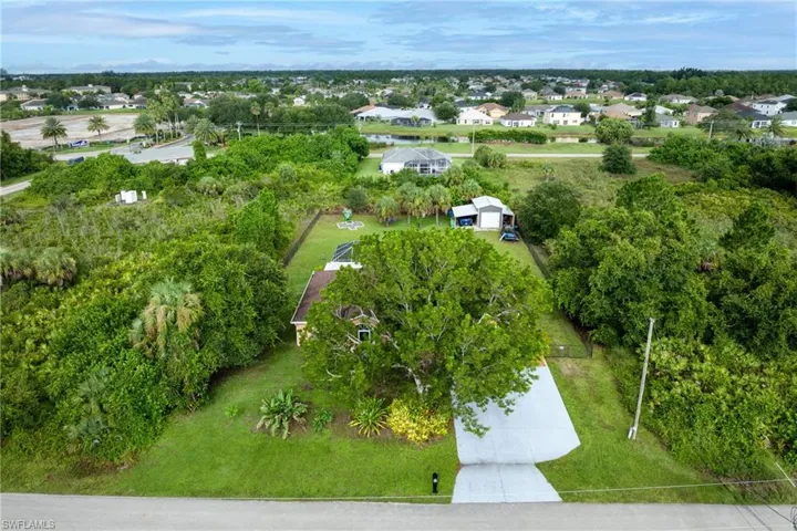 Aerial view of residential area featuring a tree filled landscape