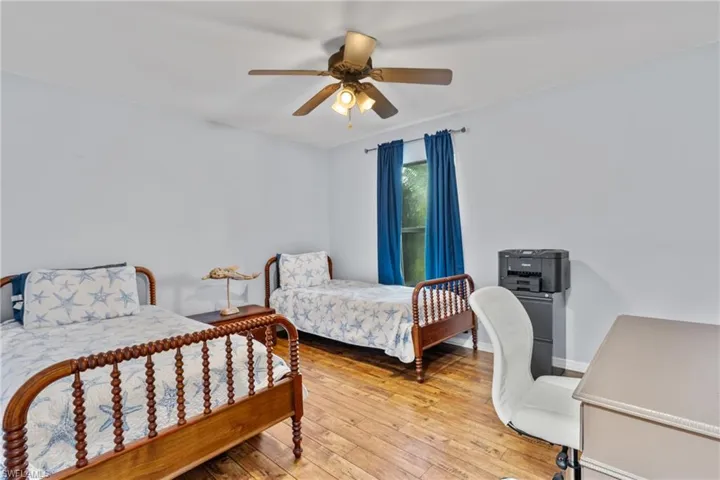 Bedroom featuring light wood-style floors and a ceiling fan