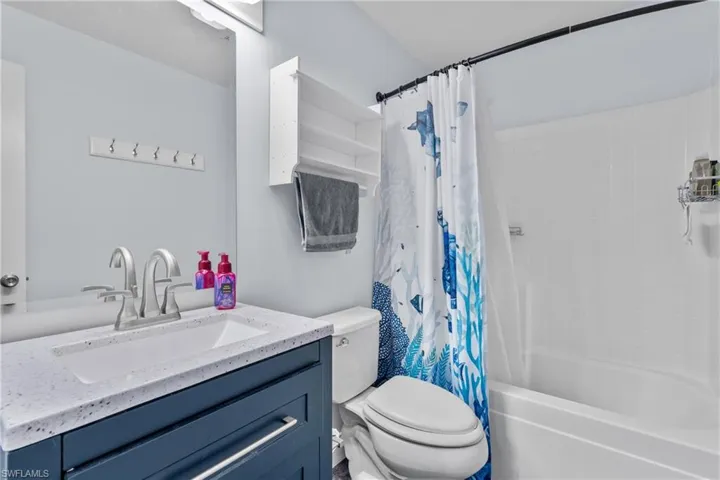 Bathroom with shower / tub combo and vanity