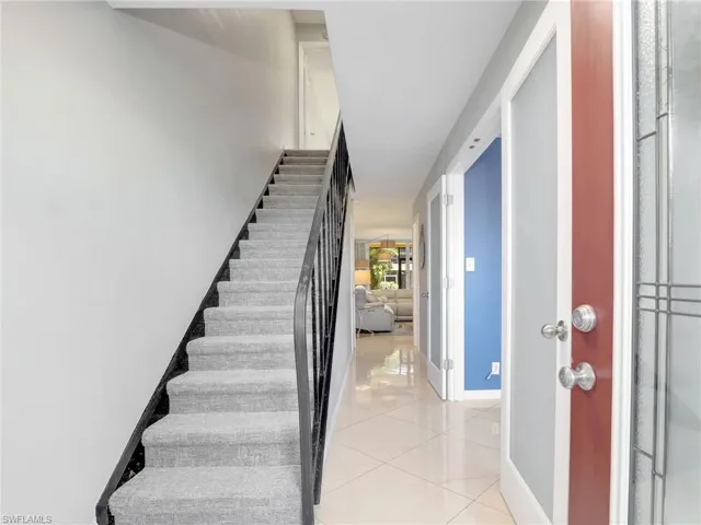 Stairwell With Doors To Den/Dining Area, Laundry & Half Bath