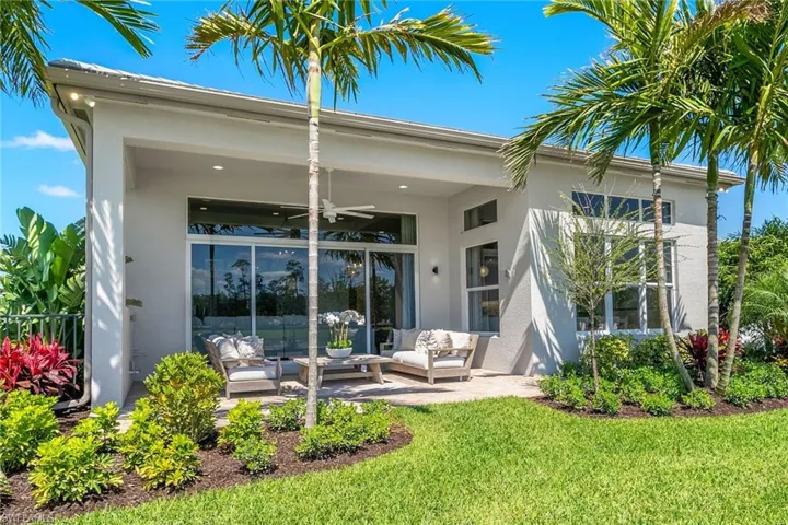Back of property featuring an outdoor hangout area, a ceiling fan, stucco siding, and a patio