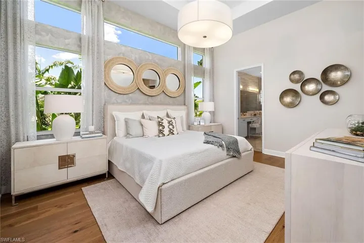 Bedroom with wood finished floors and ensuite bathroom