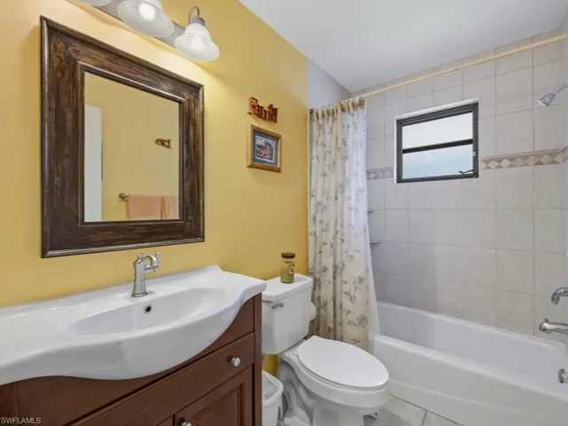 Bathroom with vanity and shower / tub combo