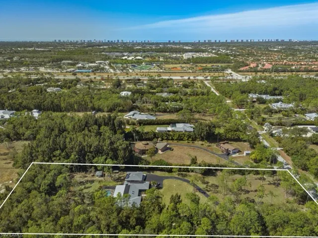 Aerial view of property's location featuring property parcel outlined and city skyline
