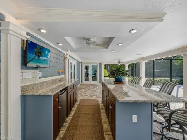 View of patio / terrace with area for grilling, ceiling fan, french doors, and glass enclosure