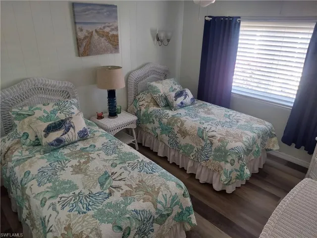 Bedroom with dark hardwood / wood-style floors