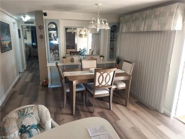 Dining area with wood-type flooring and a chandelier