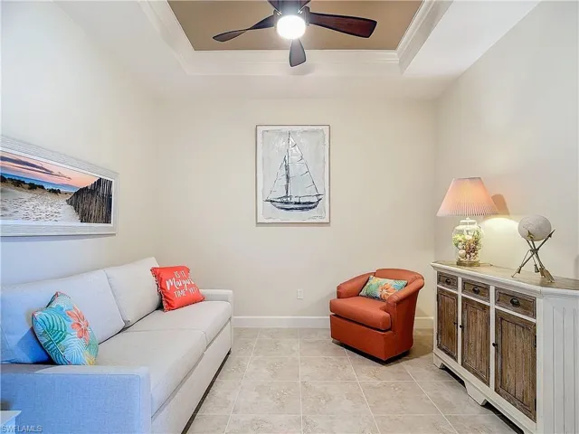 Tiled den with comfy sleeper sofa to accommodate guests and sliding doors off hallway for privacy