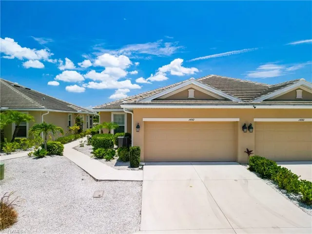 Twin Villa style home featuring a 2 car garage