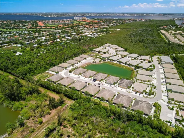 Birds eye view of property with a water view