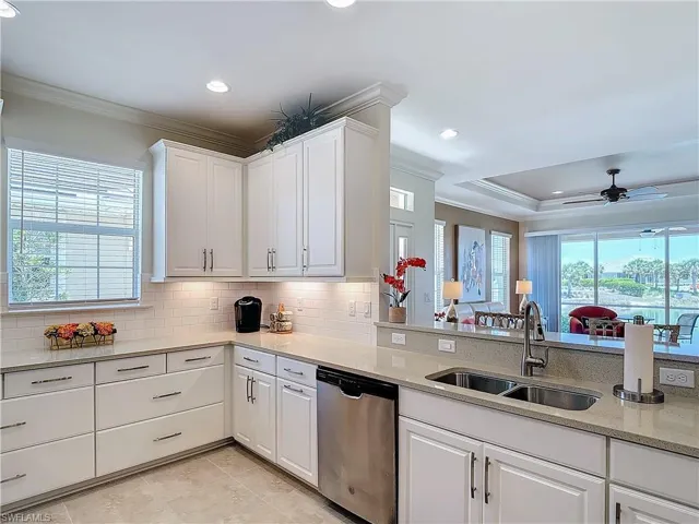 Kitchen with white cabinets, plenty of natural light, dishwasher, and ceiling fan