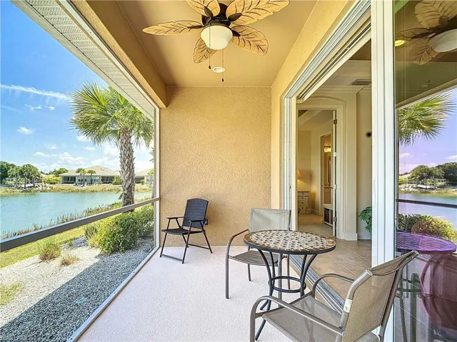 Screened lanai featuring a water view, ceiling fan and freshly painted floor.