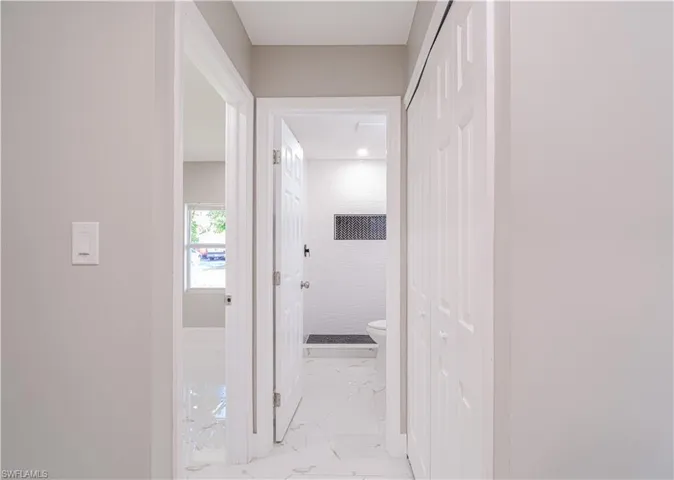 Hall with light marble finish floors