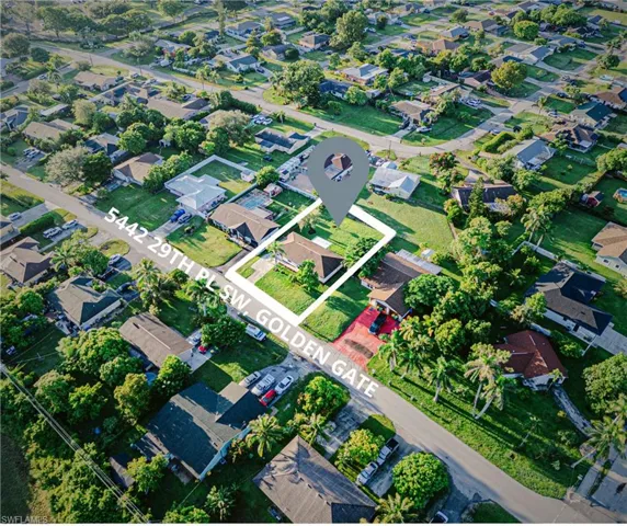 Aerial view of property's location with nearby suburban area