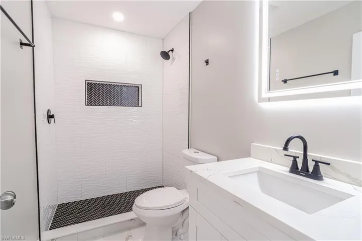 Bathroom featuring vanity and a shower stall