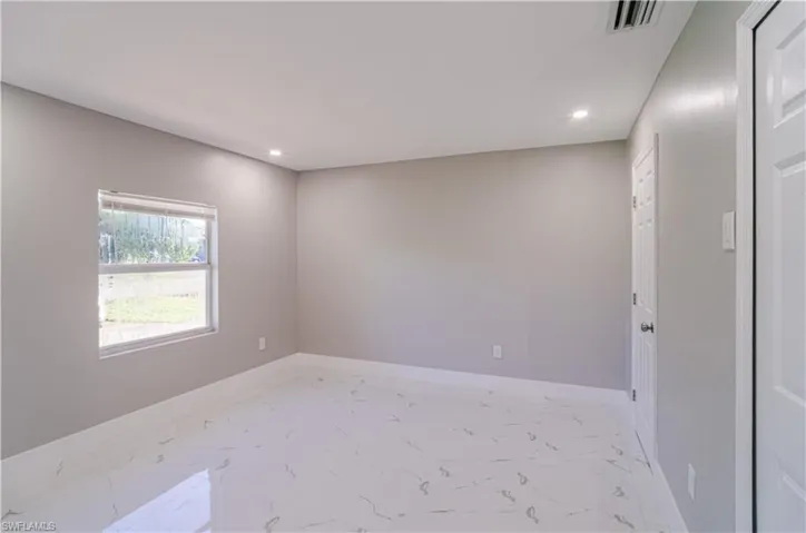 Empty room with recessed lighting and light marble finish flooring