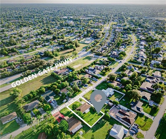 Aerial view of property's location featuring nearby suburban area