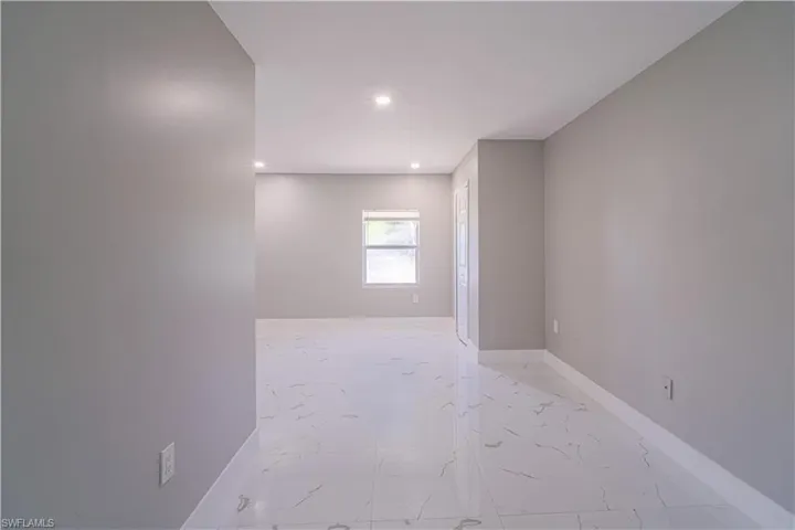 Empty room featuring recessed lighting and light marble finish floors
