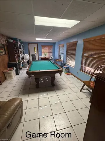 Recreation room with billiards and a drop ceiling