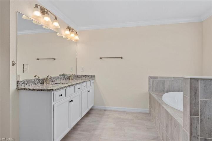 Double sinks large vanity, walk-in shower and soaking tub. Private water closet
