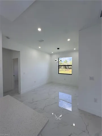 Spare room featuring recessed lighting and light marble finish floors