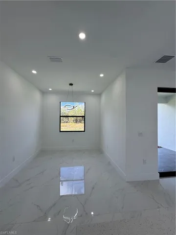 Spare room featuring recessed lighting and light marble finish floors