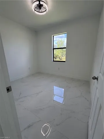 Empty room with baseboards and light marble finish flooring