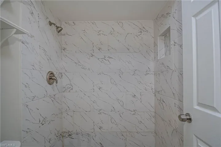 Full bath featuring tiled shower