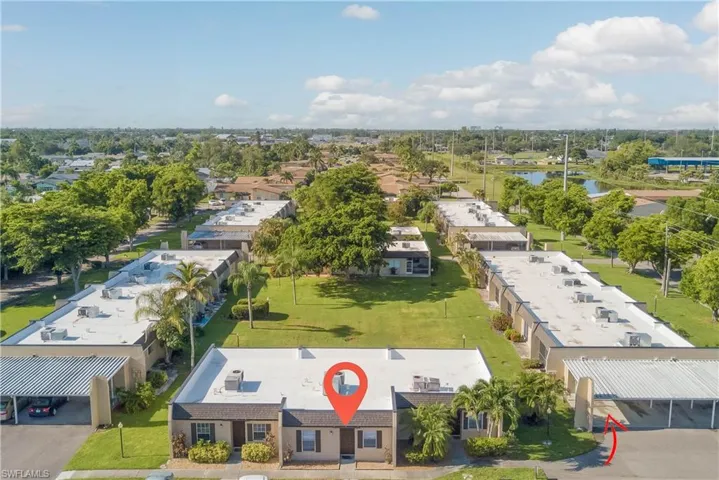 Aerial perspective of suburban area featuring a nearby body of water