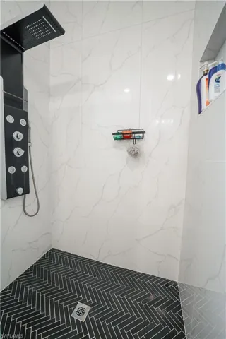 Full bathroom featuring a marble finish shower