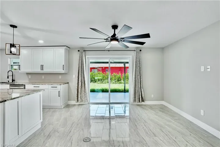 Living room with plenty of natural light, recessed lighting and ceiling fan.
