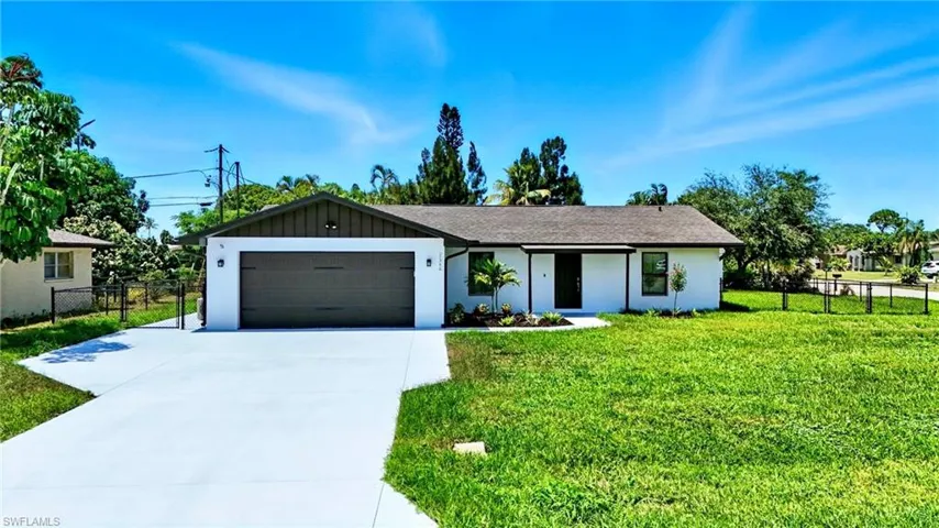 Ranch-style house featuring driveway, an attached garage, and stucco siding