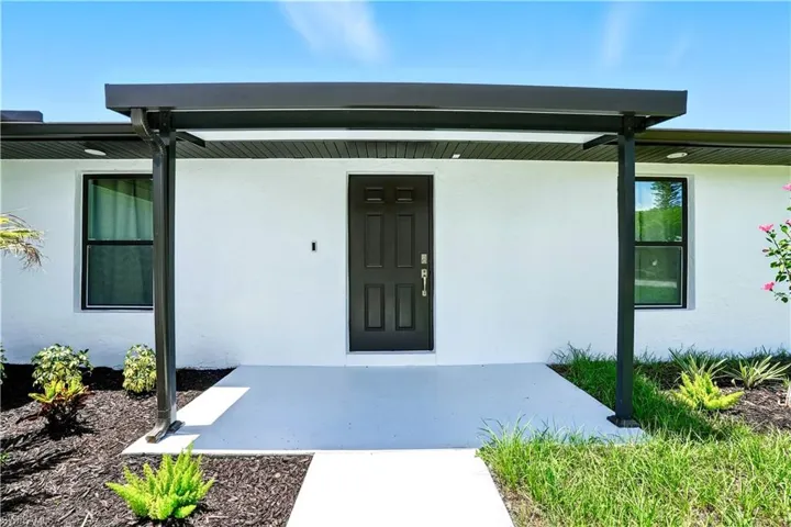View of exterior entry featuring stucco siding