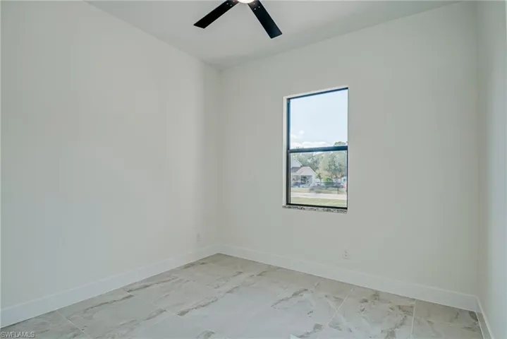 Unfurnished room with baseboards