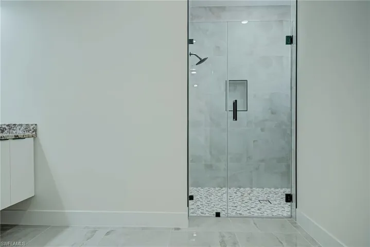 Full bath featuring a shower stall and vanity