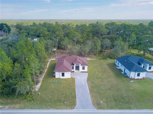 View from above of property featuring a heavily wooded area