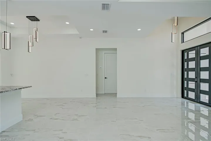 Entrance foyer with recessed lighting and light marble finish flooring