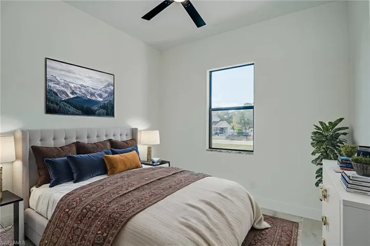 Bedroom featuring baseboards and ceiling fan