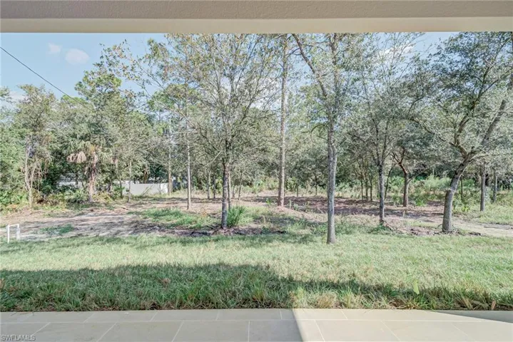 View of yard with view of wooded area